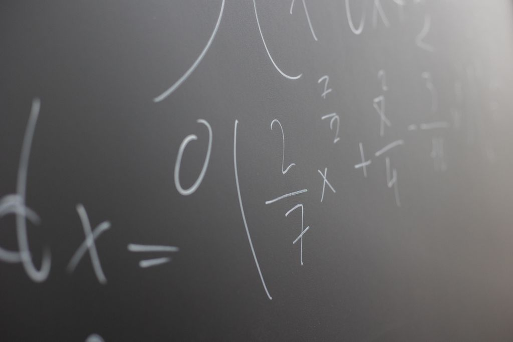 Blackboard with handwritten mathematical example for solve on lesson during studies in classroom of university
